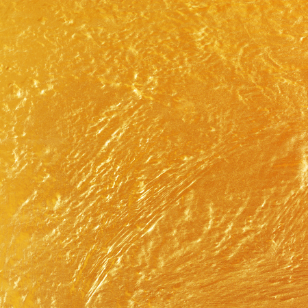 Gold or yellow paint on cement wall texture or backgrond