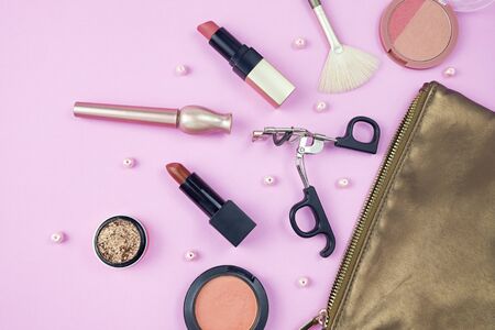 Makeup brushes and tools, make-up products set isolated on pink background.