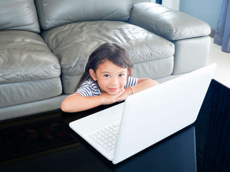 A Girl studying lesson online  from home on laptop. social distance during quarantine,...