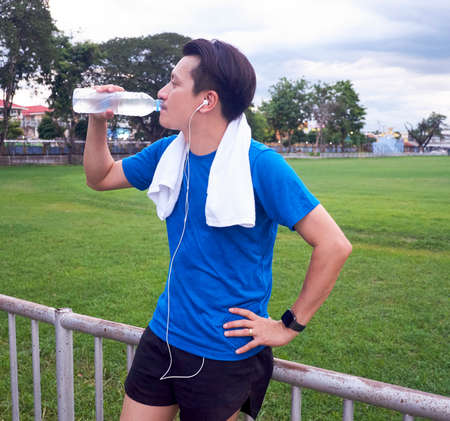 Portrait of a young man in sportswear using his smart watch after training.