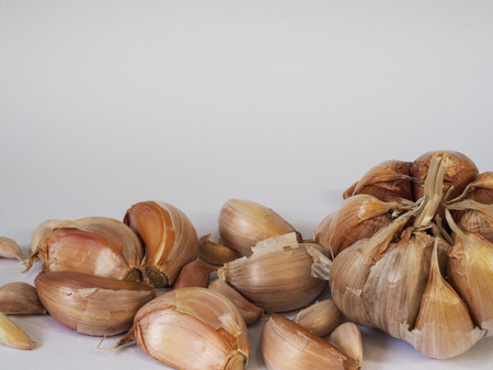 Garlic bulb and garlic cloves on a white background.の写真素材