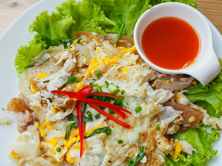 Fried noodles with chicken and chilli sauce.の写真素材