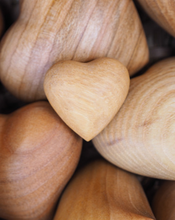 various sizes of wooden hearts in the basketの写真素材