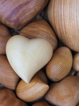 various sizes of wooden hearts in the basketの写真素材