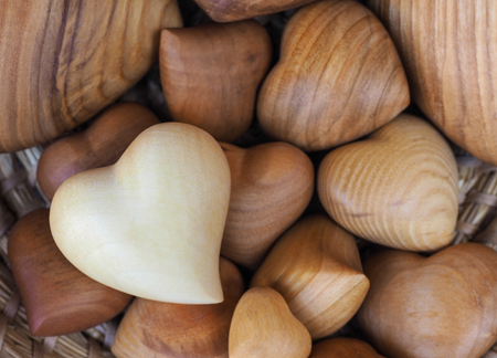 various sizes of wooden hearts in the basketの写真素材