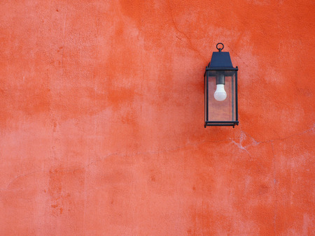 Orange wall with lamp.の写真素材