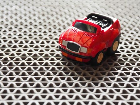 A red toy car park on rough floorの写真素材