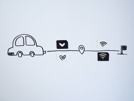 A drawing car and small paper simulated as a SIM card. Dollar and wifi symbol on paper sim cardsの写真素材