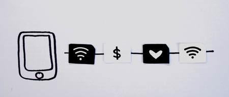 Drawing smart phone and small paper simulated as a SIM card. Dollar, wifi and heart symbol on paper sim cards. Focus on drawing phoneの写真素材
