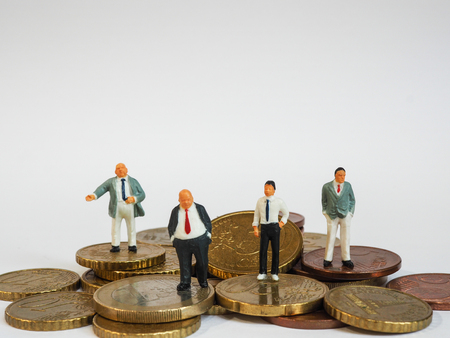 Miniature businessman stand on Euro coins and book bank. Business and idea conceptの写真素材