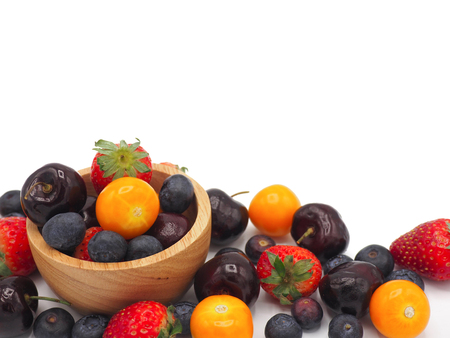 Fresh summer fruits, Cherry, strawberry, cape gooseberry and blueberry in wooden bowl isolated on white background.の写真素材