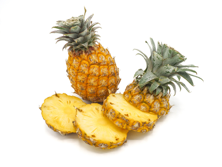 Fresh pineapple fruit with slices on white backgroundの写真素材