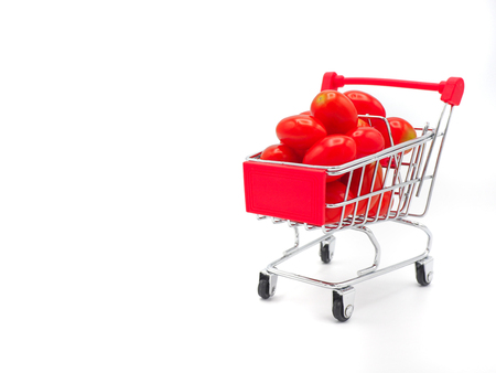 Fresh grape or cherry tomato in shopping cart on white background.の写真素材