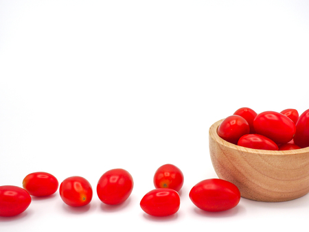 Fresh grape or cherry tomato in wooden bowl on white background.の写真素材