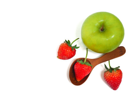 Stethoscope, fresh green apple and strawberry on white background. Healthy food and lifestyle concept.の写真素材