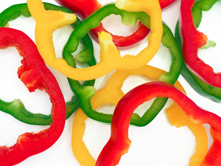 Fresh vegetables, red, yellow, green sweet peppers on white background.の写真素材