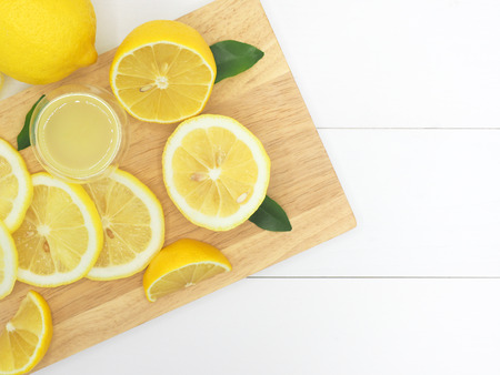 Fresh lemon slice with lemonade on white wood backgroundの写真素材