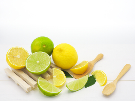 Fresh lemon slice and lime on white wood backgroundの写真素材