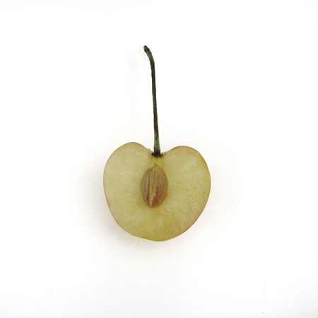 Sweet and healthy Rainier cherries, cut in half with bone, on white background, fresh fruitsの写真素材
