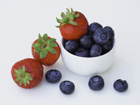 Fresh and sweet strawberry and blueberry on white background, healthy fruit and diet.の写真素材