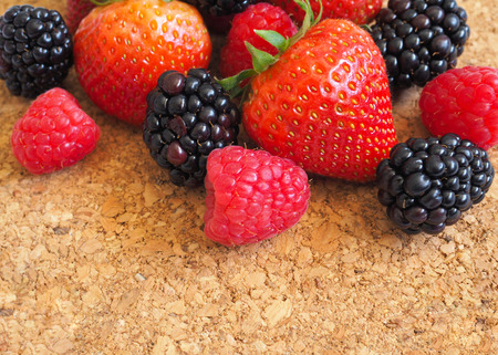 Fresh strawberry, raspberry and blackberry on wooden background, healthy food and diet.の写真素材