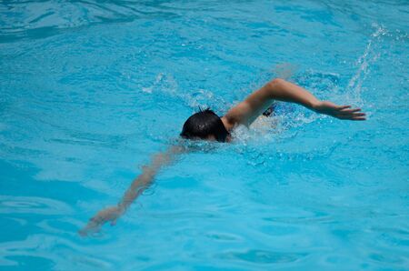 the man swimming in the poolの写真素材