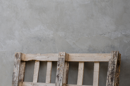 wooden fence laid against to concrete wallの写真素材