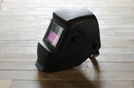 welding helmets on wooden floorの写真素材
