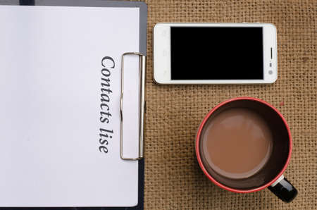 smart phone with coffee and paperの写真素材