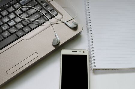 earphone on the laptop with smart phone and notebookの写真素材