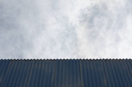 old blue roofing tiles with skyの写真素材