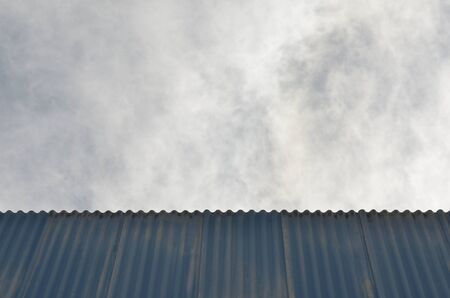 old blue roofing tiles with skyの写真素材