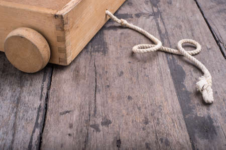 toy cart with rope on the wood deskの写真素材