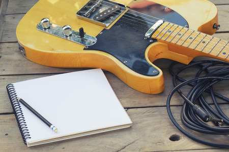 Telecaster with notepad on wood tableの写真素材