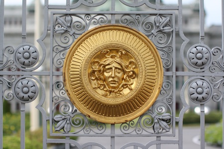 Golgen medusa head at fence of palaceの写真素材