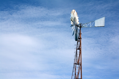 Old wind turbine in blue skyの写真素材