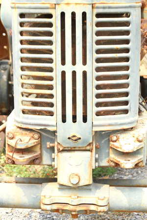 Rusty old tractor sits alone in the field on a farmの写真素材