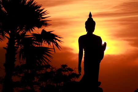 black shadow of big Buddha statue with evening sunset backgroundの写真素材