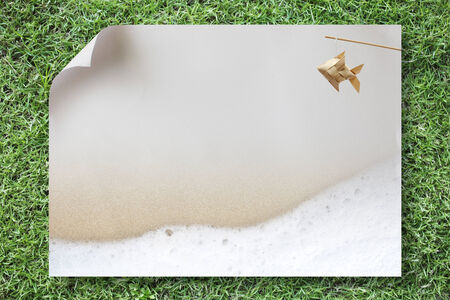 Paper a4 and grass backgroundの写真素材