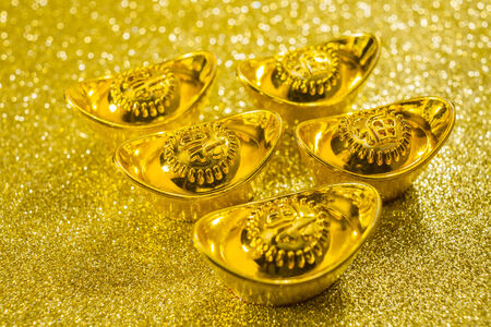 Gold bars on gold swirl backgroundの写真素材