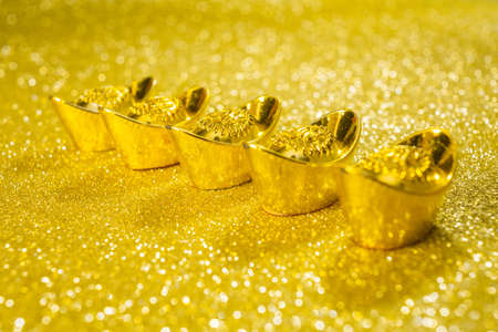 Gold bars on gold swirl backgroundの写真素材