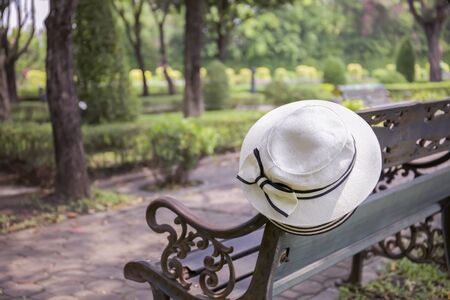 White hat on a bench in the gardenの写真素材