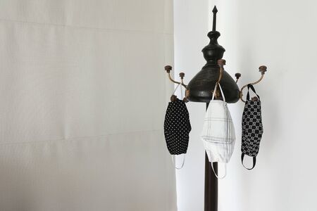 handmade clothes face masks hanging on clothes line after washed. Face mask is be come necessary for...