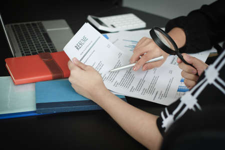business team analysing financial data with a magnifying glassの写真素材