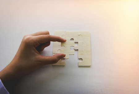 Businessman hands connecting jigsaw puzzle. Business solutions, success and strategy, learning...