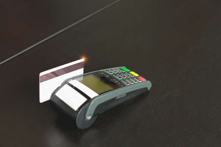 Credit card swipe machine for sell products in the shop. Concept of spending via credit card.の写真素材