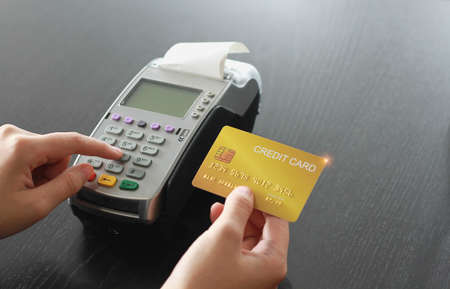 Credit card swipe machine for sell products in the shop. Concept of spending via credit card.の写真素材