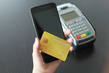 A woman using credit card on smartphone  for buy products in the shop. Concept of spending via credit card on line shopping.の写真素材