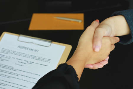 Business handshake. Two businessmen reaching an agreement and making a deal.