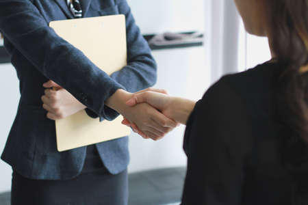 Business handshake. Two businessmen reaching an agreement and making a deal.